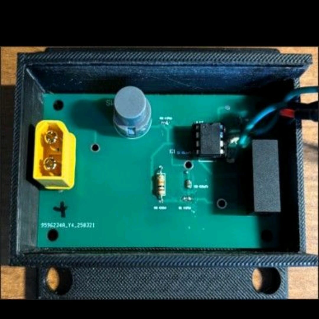 The Firefighter BLI with its enclosure cover removed, showing the custom PCB inside, including voltage regulation circuitry and the OLED display module.